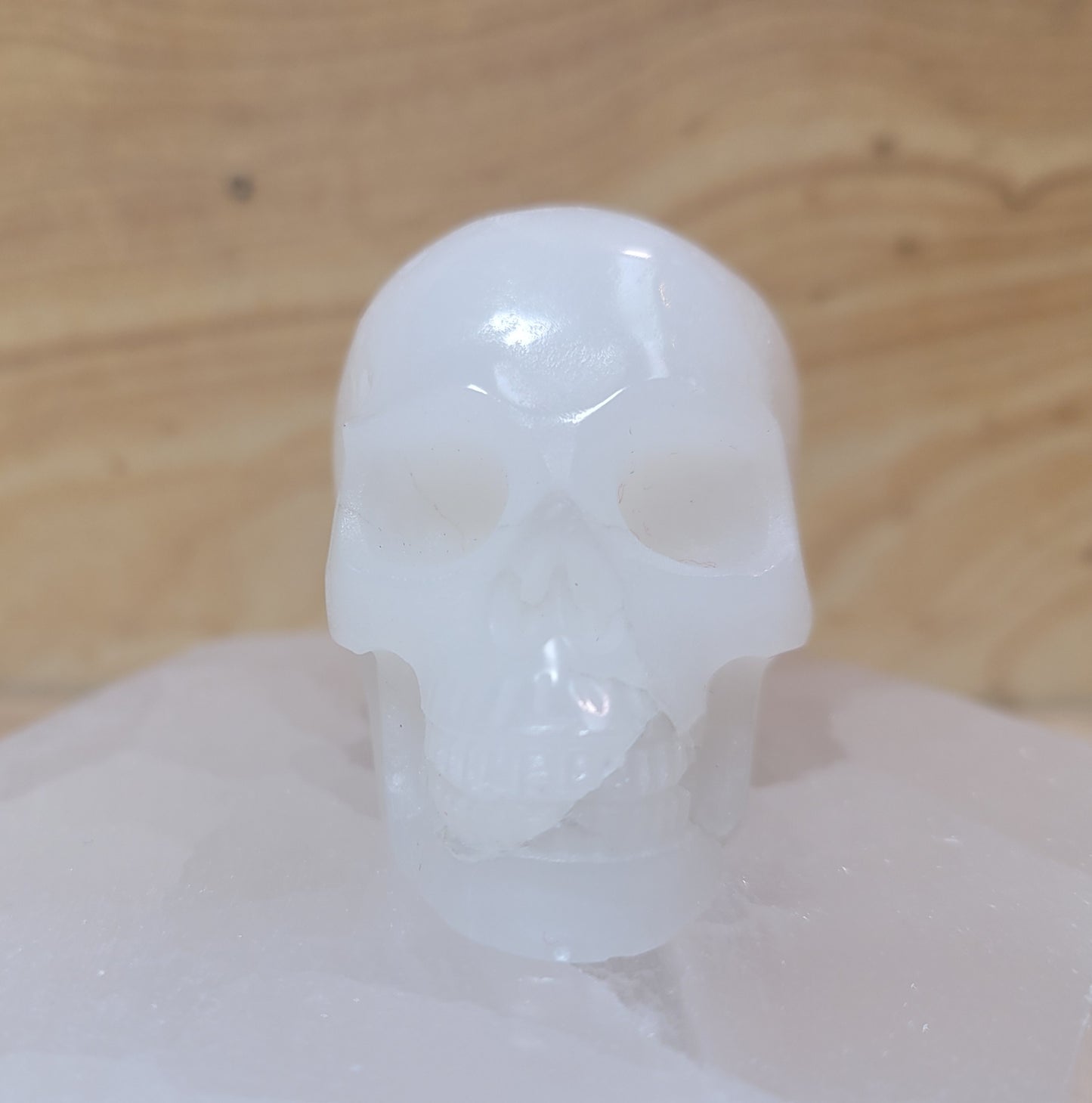 A beautifully carved Afghanistan white jade skull, showcasing a smooth, pure white surface with subtle variations, displayed on a soft, neutral background. This unique piece symbolizes emotional balance, serenity, and wisdom, making it an elegant decorative item.