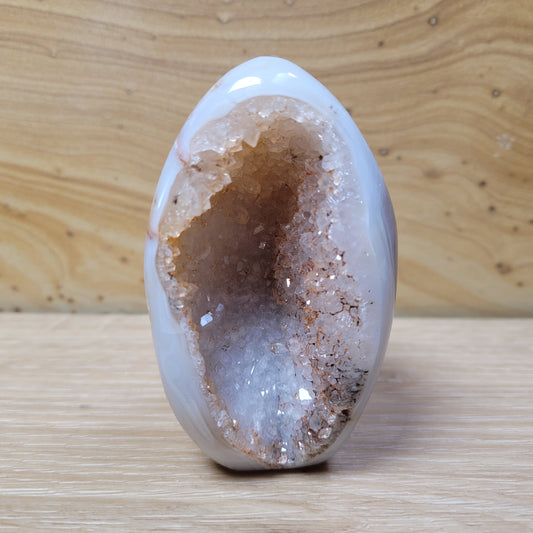 A stunning Agate Quartz Free Form, showcasing intricate banding and earthy tones with a polished, translucent surface, displayed against a soft, neutral background. This unique piece symbolizes grounding, emotional balance, and clarity, making it an elegant decorative item.