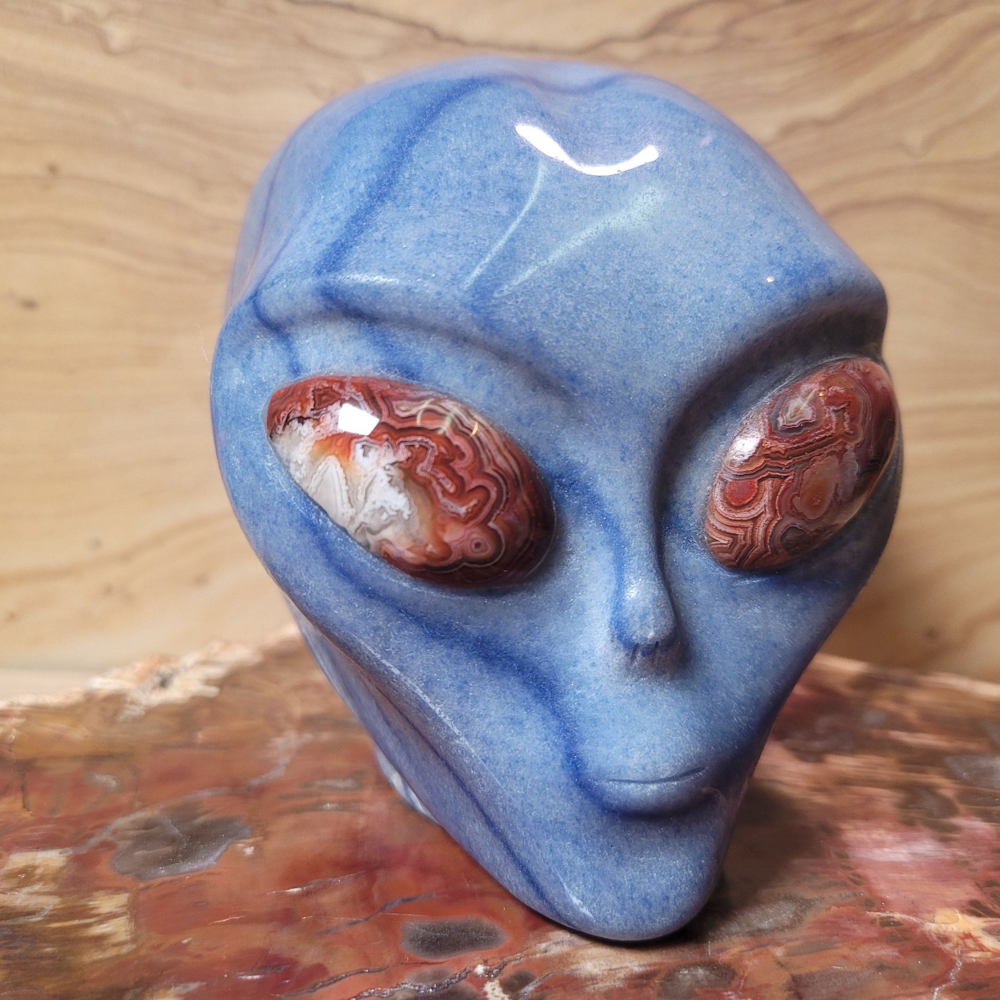 A whimsical Blue Aventurine with Crazy Lace Alien Figurine, measuring 4.2 inches tall, featuring soothing blue hues and intricate lace-like patterns, displayed against a soft, neutral background. This unique piece symbolizes exploration, creativity, and joy, making it an enchanting decorative item.