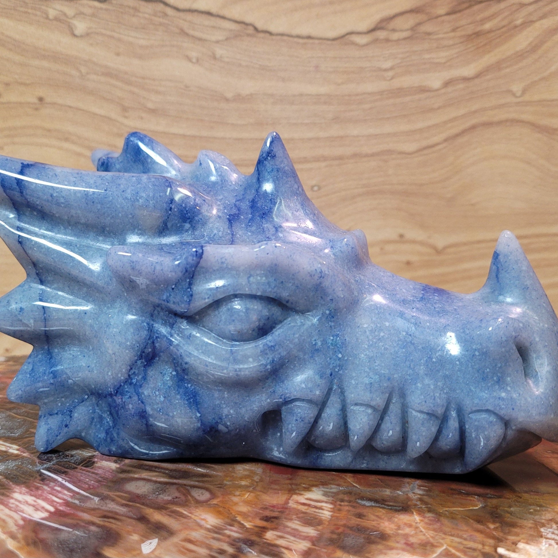 A stunning Blue Aventurine Dragon Figurine, measuring 5 to 8 inches tall, showcasing gentle blue hues and intricate carvings, displayed against a soft, neutral background. This unique piece symbolizes strength and transformation, making it a captivating decorative item.