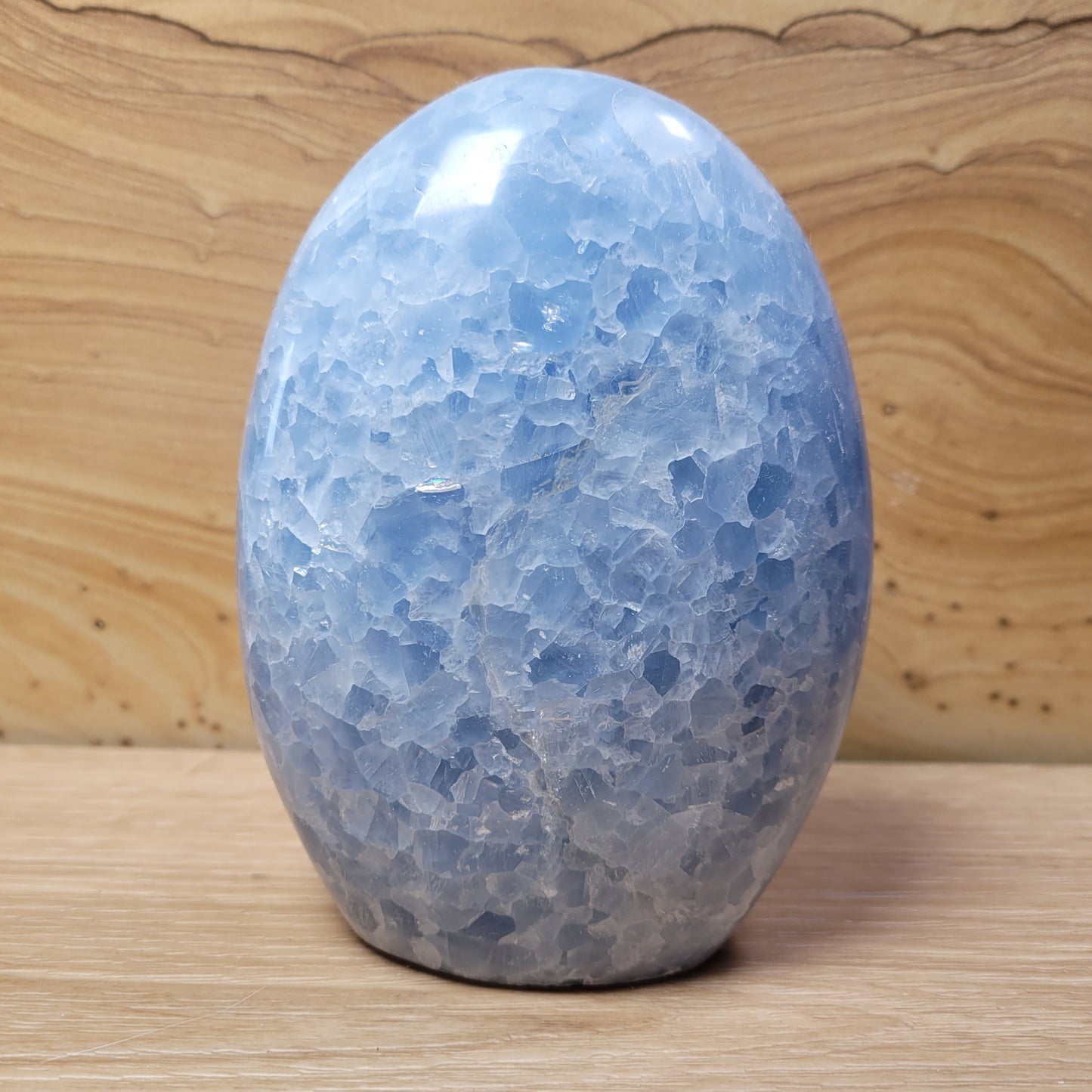 A beautiful Blue Calcite specimen showcasing serene blue hues and unique crystalline formations, displayed against a soft, neutral background. This stunning piece symbolizes relaxation, emotional healing, and improved communication, making it an elegant decorative item.