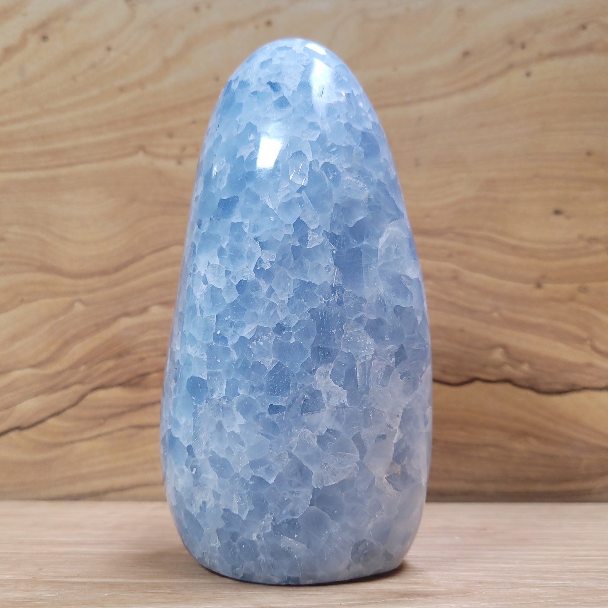 A beautiful Blue Calcite specimen showcasing serene blue hues and unique crystalline formations, displayed against a soft, neutral background. This stunning piece symbolizes relaxation, emotional healing, and improved communication, making it an elegant decorative item.