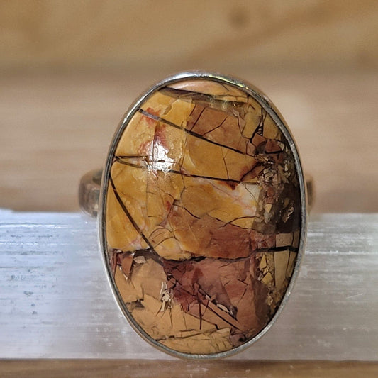 Brecciated mookaite adjustable ring featuring warm tones of red, yellow, and brown, showcasing unique patterns in a stylish design, promoting grounding and emotional healing.