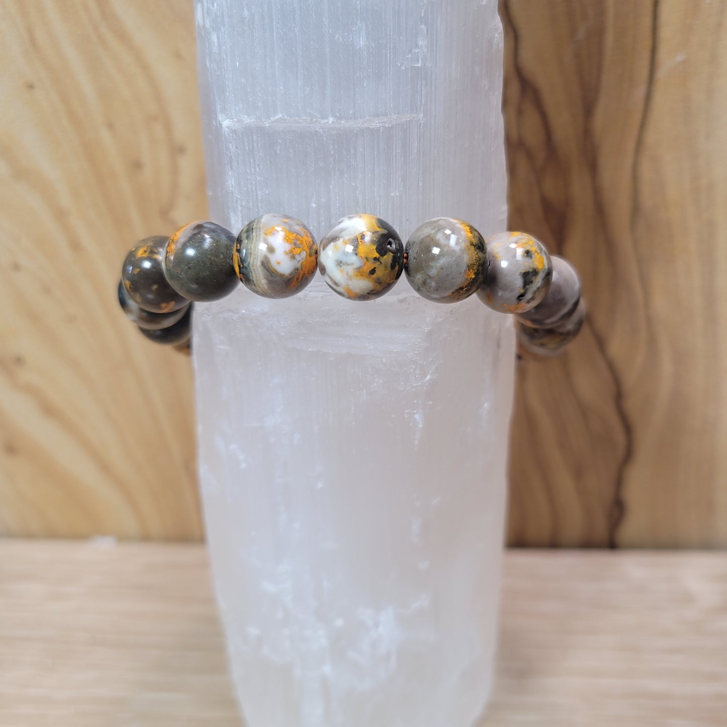 11mm bumblebee jasper bracelet featuring vibrant yellow, orange, and black beads, known for its creativity, energy, and emotional balance metaphysical properties.