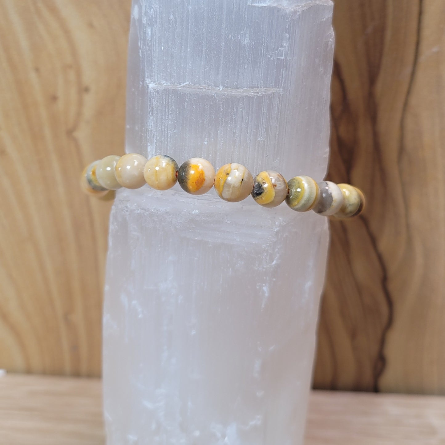 11mm bumblebee jasper bracelet featuring vibrant yellow, orange, and black beads, known for its creativity, energy, and emotional balance metaphysical properties.