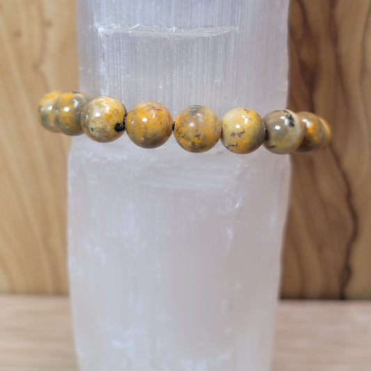 11mm bumblebee jasper bracelet featuring vibrant yellow, orange, and black beads, known for its creativity, energy, and emotional balance metaphysical properties.