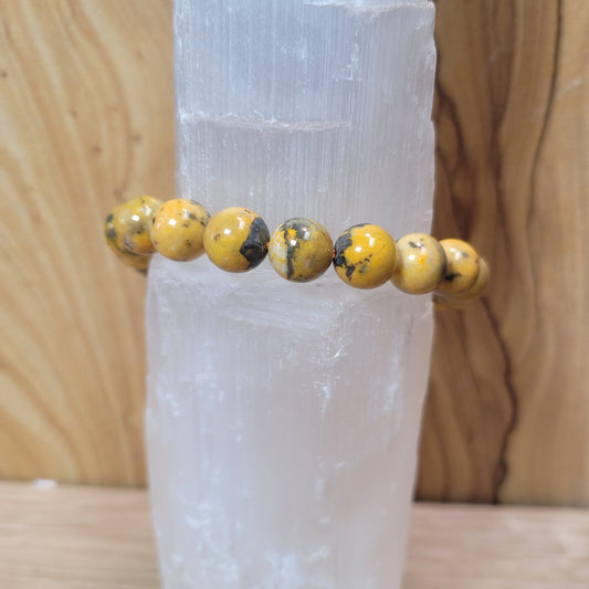 9mm bumblebee jasper bracelet featuring vibrant yellow, orange, and black beads, known for its creativity, energy, and emotional balance metaphysical properties.