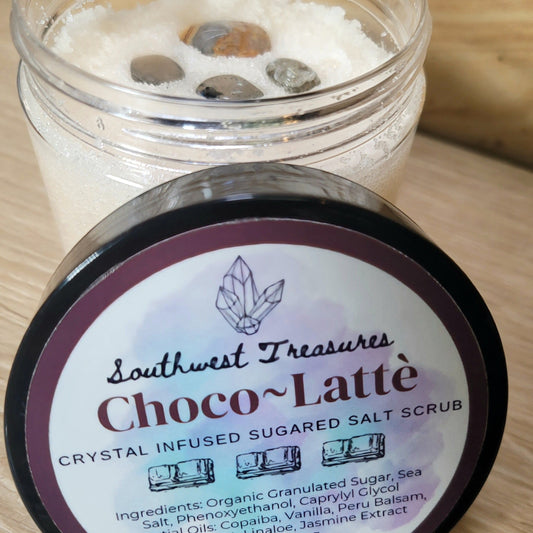 Choco Latte Crystal-Infused Sugared Salt Scrub – Indulge in this luxurious scrub featuring a rich choco latte scent and the exfoliating power of sugar and salt. Infused with crystals, this scrub not only smooths and refreshes your skin but also imparts cleansing and balancing energies. Perfect for a relaxing self-care ritual, it combines the benefits of aromatherapy with the unique properties of crystal energy for a rejuvenating experience.